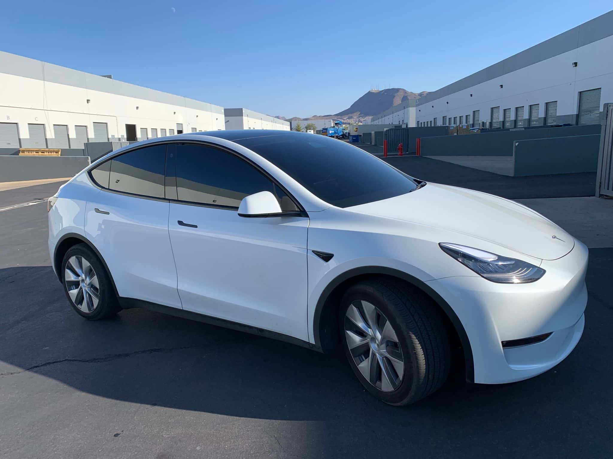Window tinting Las Vegas: white Tesla Model Y with ceramic window tint