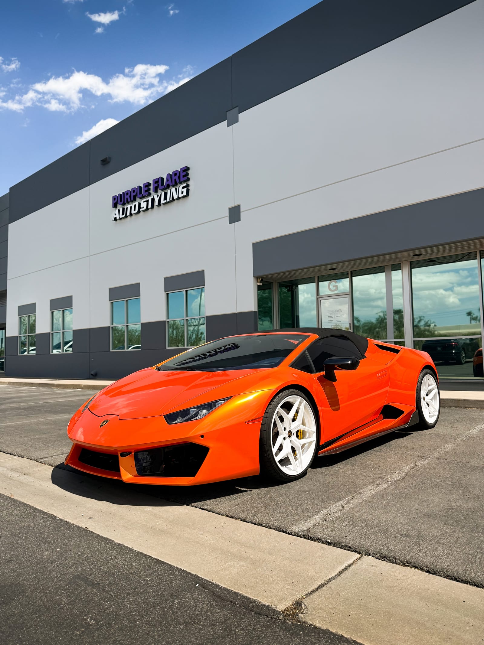 lamborghini huracan wrap — orange Lamborghini Huracan Spyder parked outside the Henderson shop