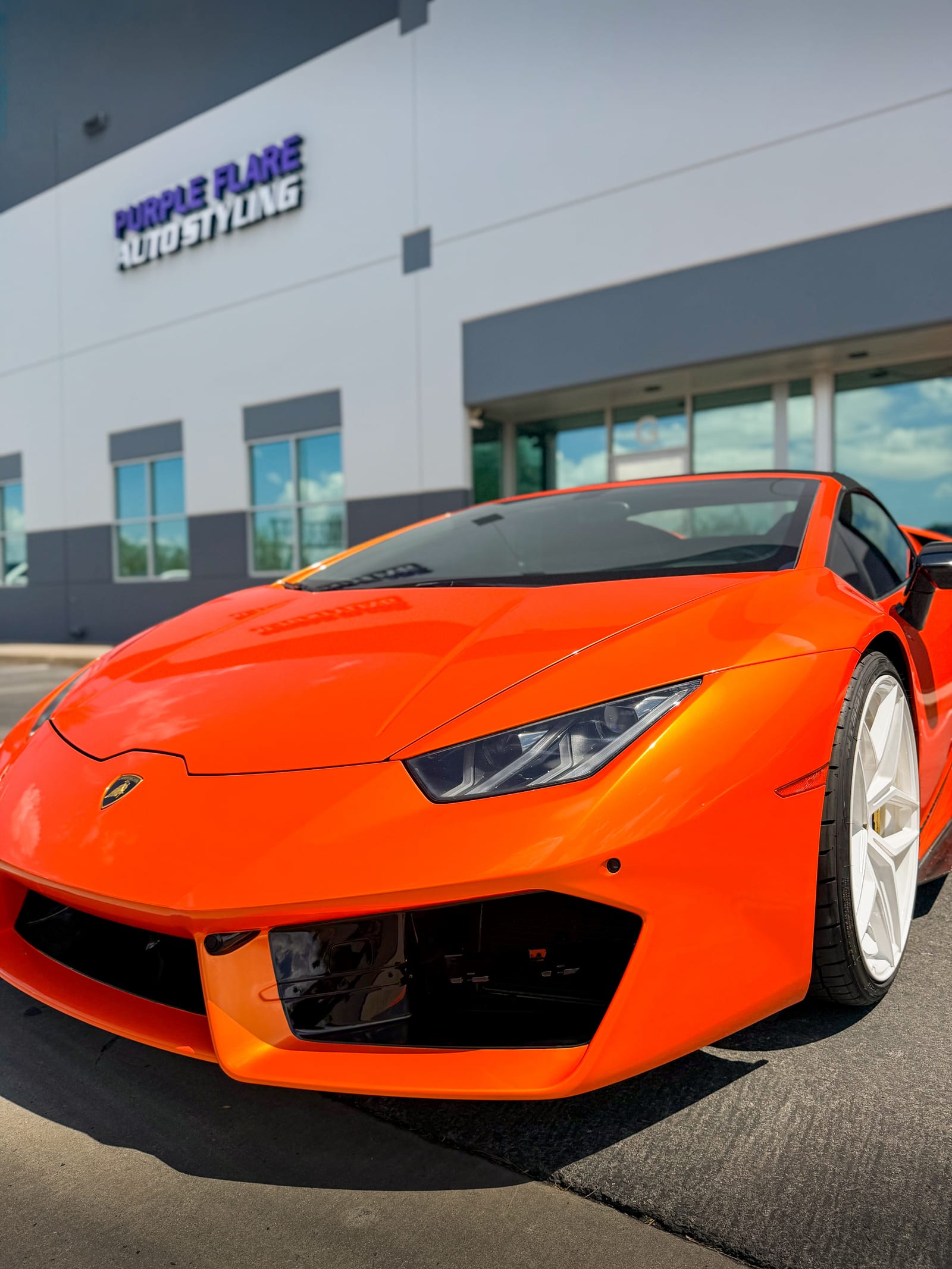 lamborghini huracan wrap — front three-quarter view of the gloss orange Lamborghini Huracan Spyder