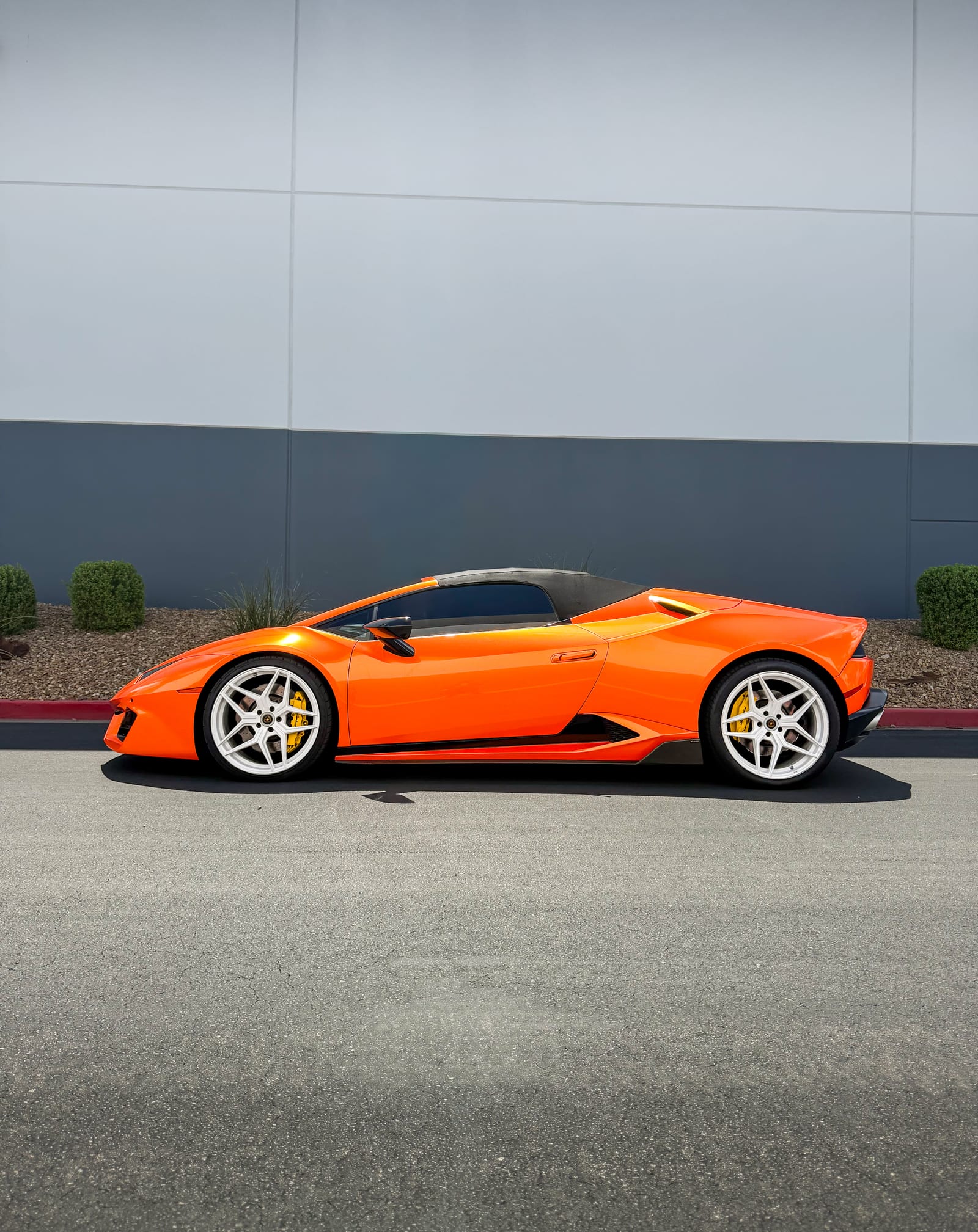 lamborghini huracan wrap — side profile of the gloss orange Lamborghini Huracan Spyder on white wheels
