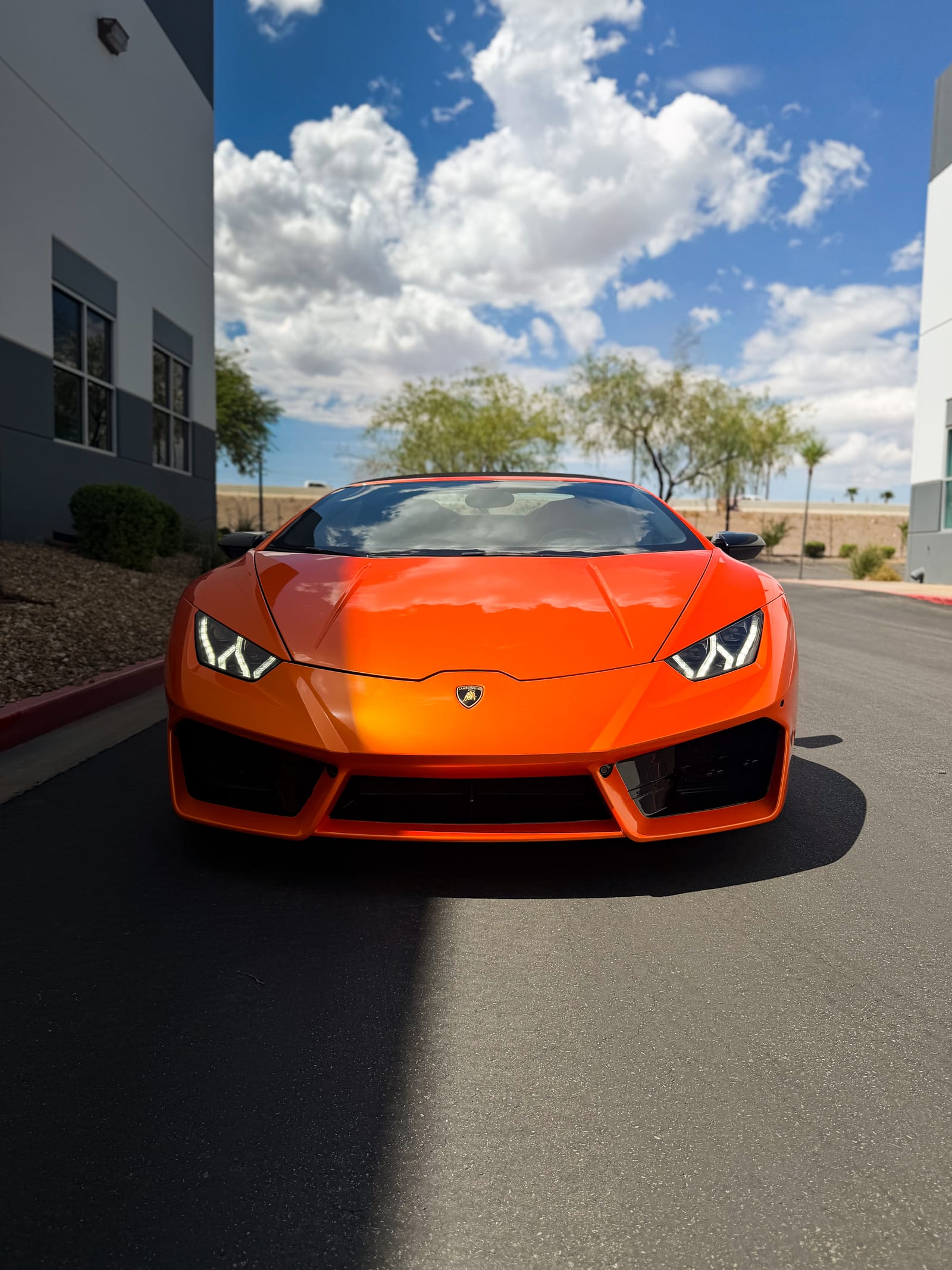 lamborghini huracan wrap — head-on front view of the gloss orange wrapped Lamborghini Huracan