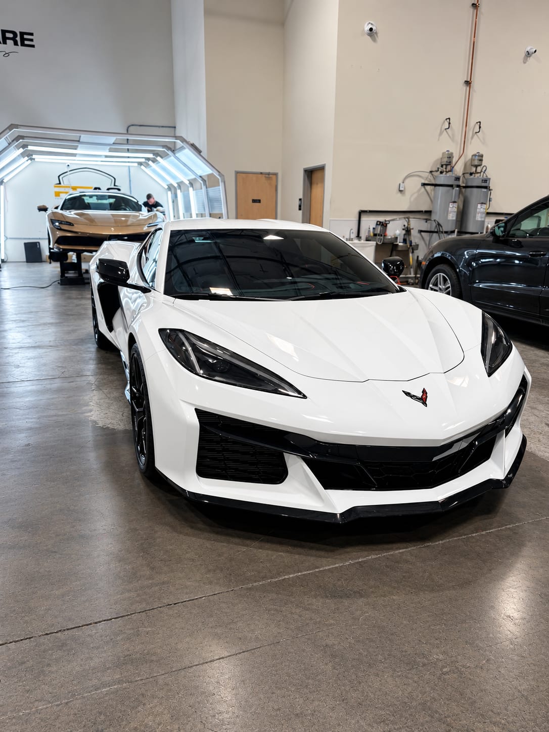 corvette z06 ppf — white C8 Corvette Z06 front view in the Henderson shop after full front PPF and ceramic tint