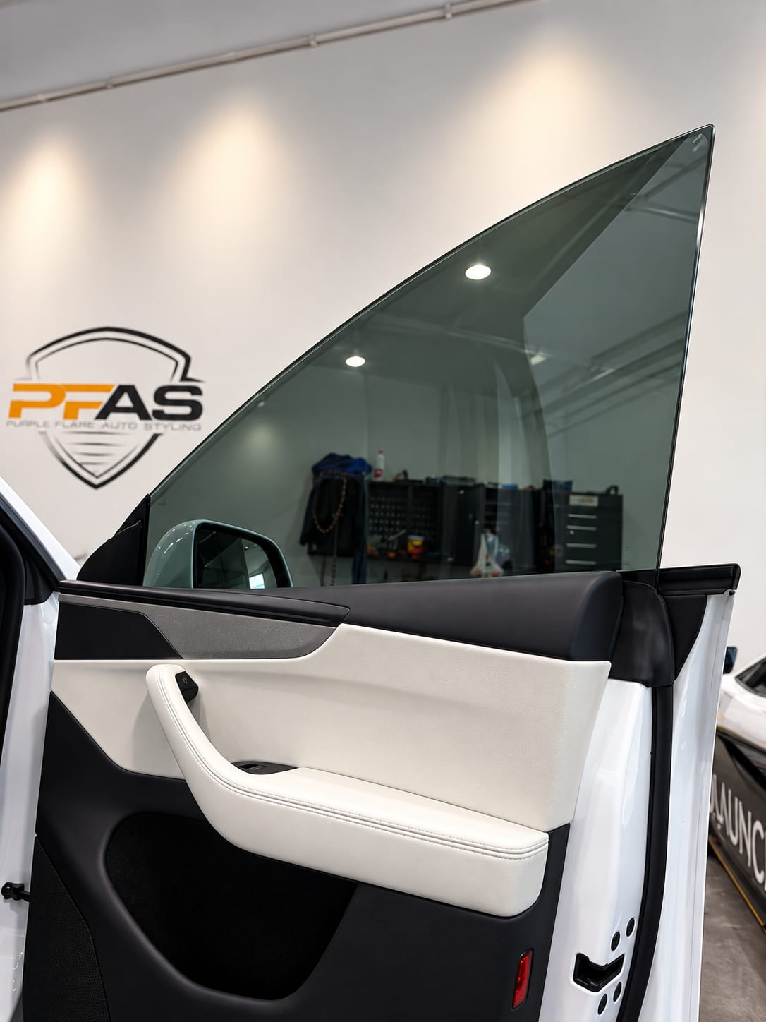 model y l ppf — ceramic window tint on the front door glass of a Tesla Model Y L at Purple Flare Wraps