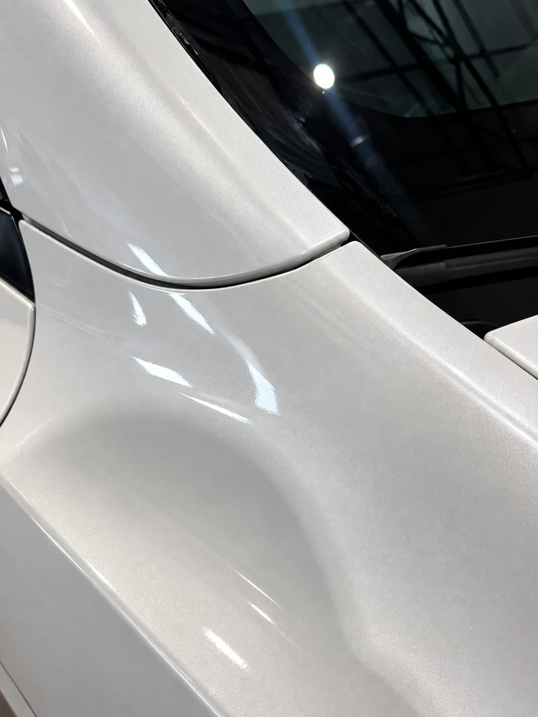 Close-up of paint protection film wrapped around the edge of a fender
