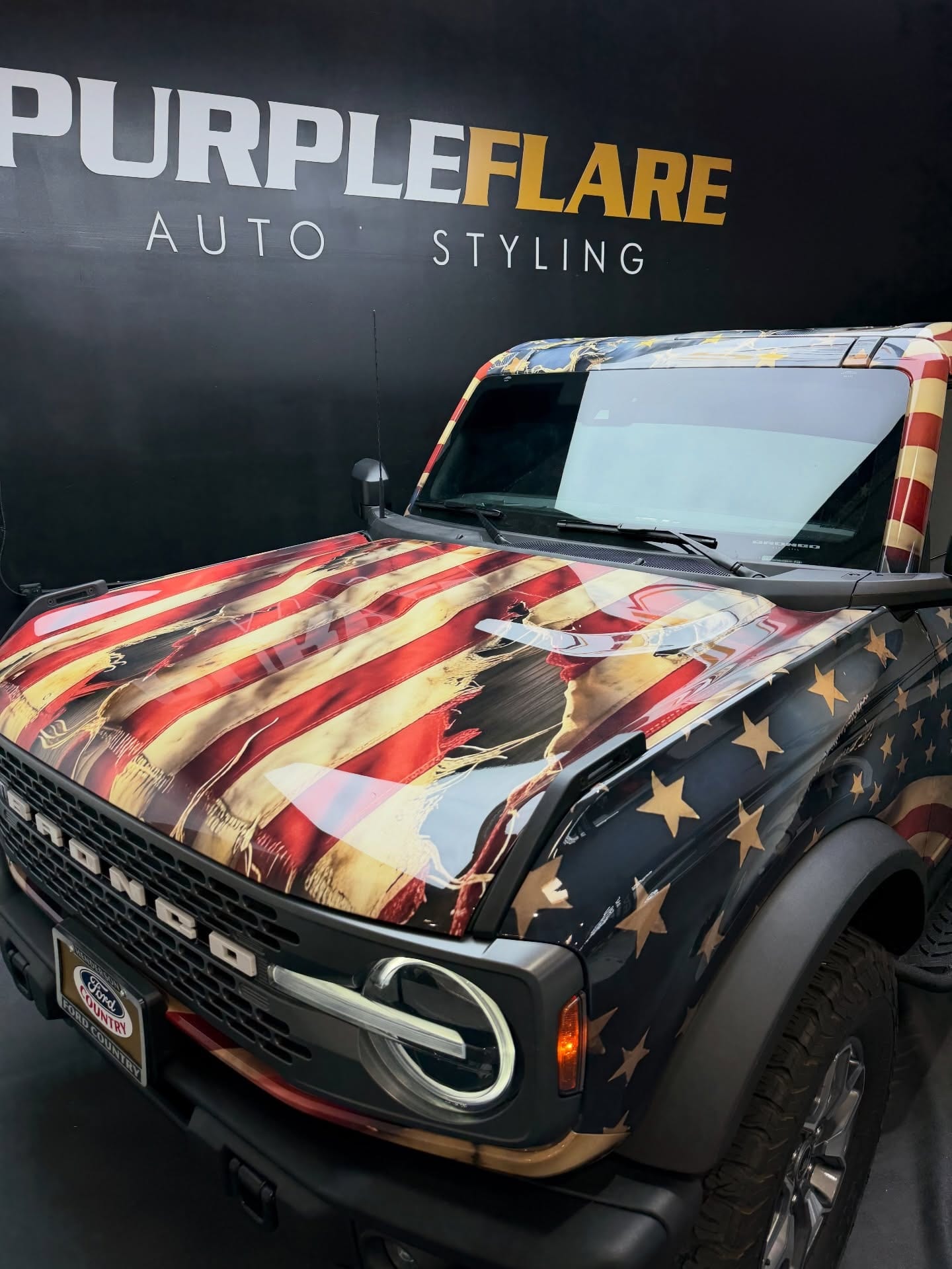 printed ppf wrap — high-gloss printed PPF hood on a Ford Bronco showing a distressed American flag design