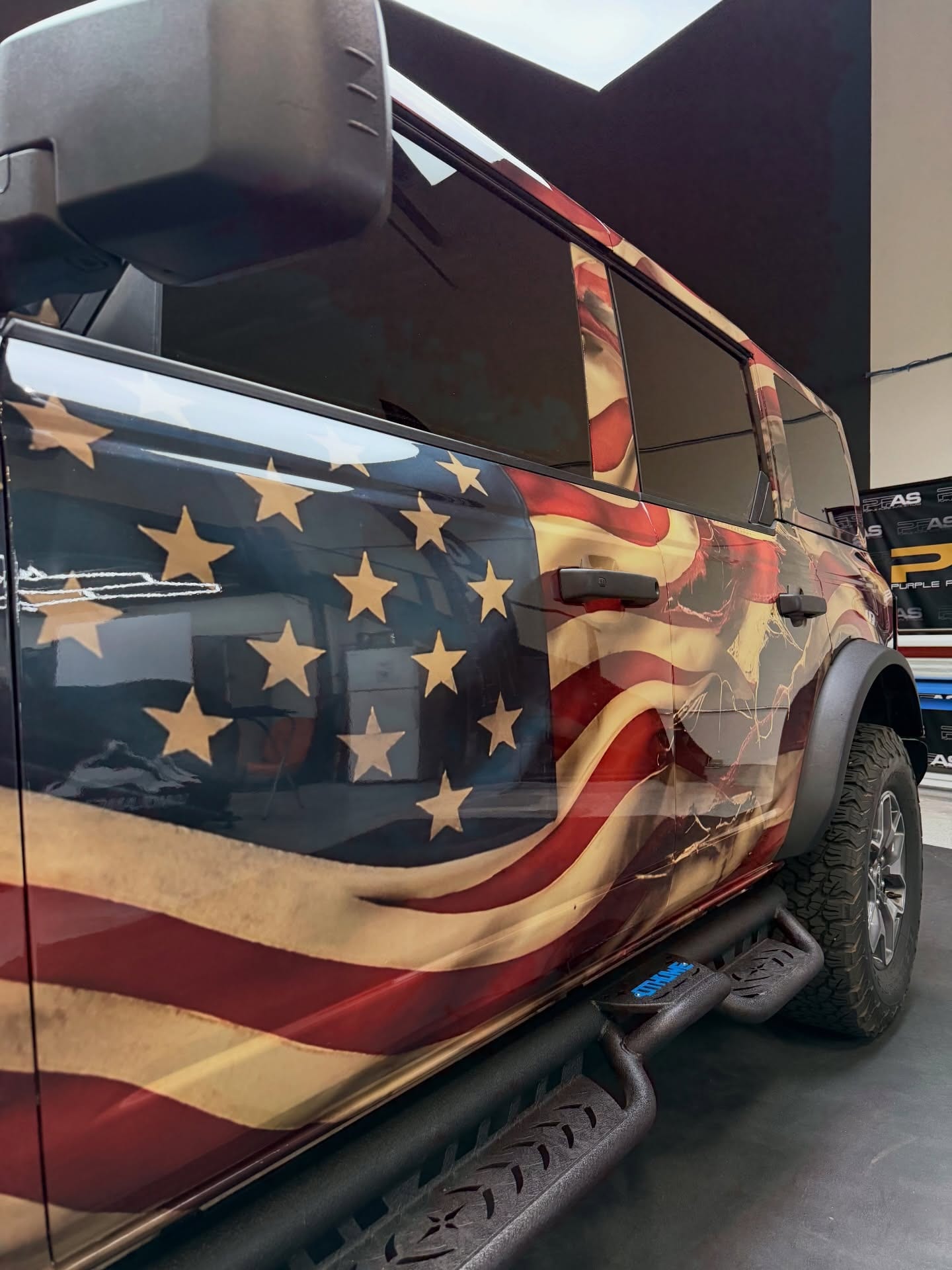 printed ppf wrap — side of a Ford Bronco with printed paint protection film stars and waving flag stripes