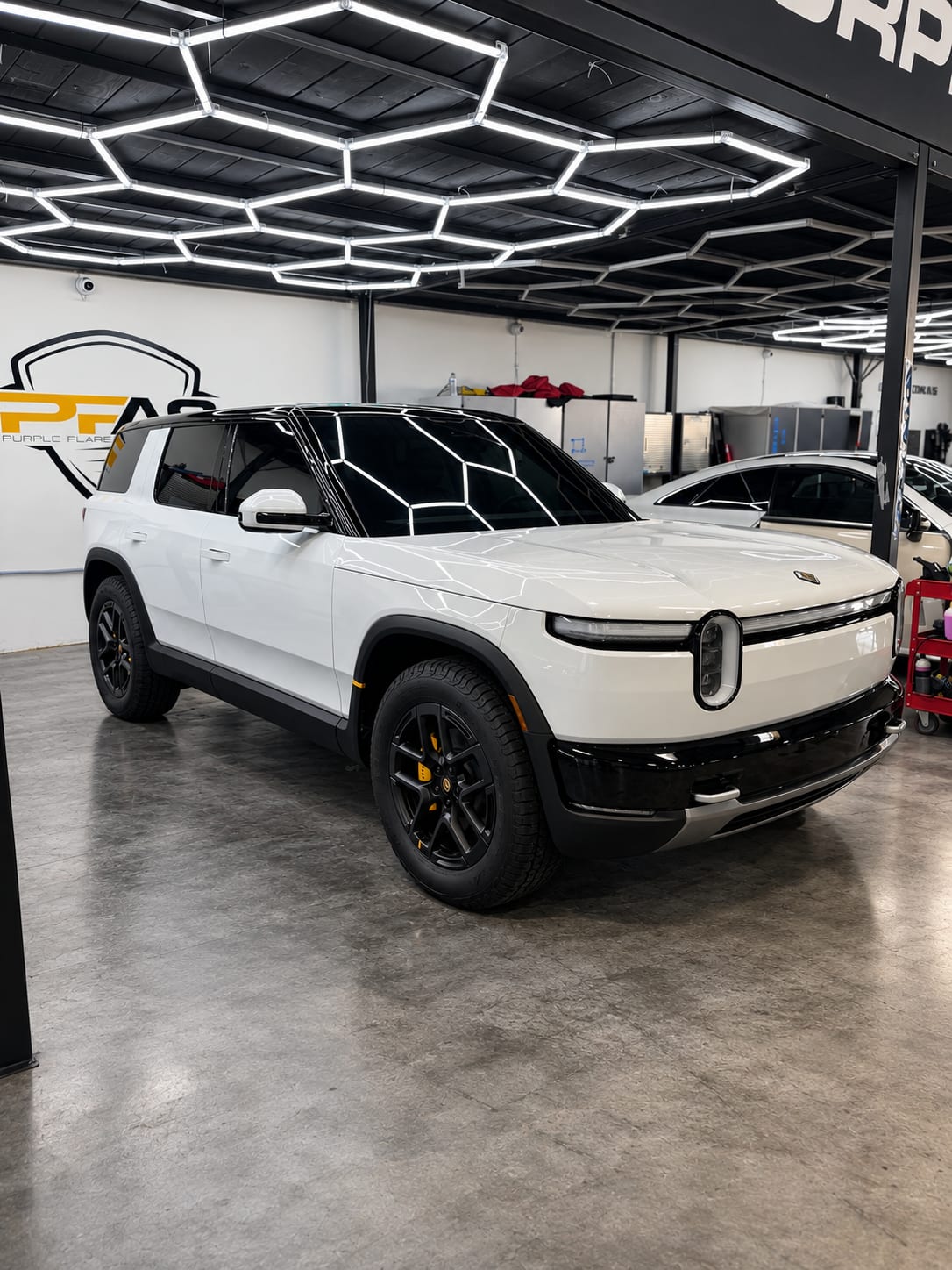 rivian r2 paint protection — white Rivian R2 in the Henderson shop after paint correction, PPF, ceramic coating and tint