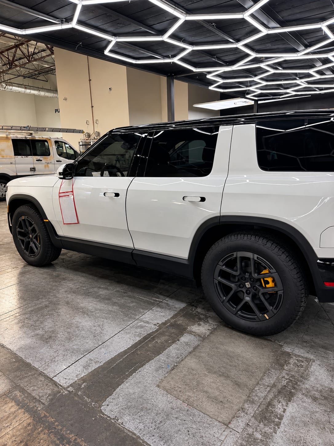 rivian r2 paint protection — side profile of the white Rivian R2 with ceramic window tint on every window