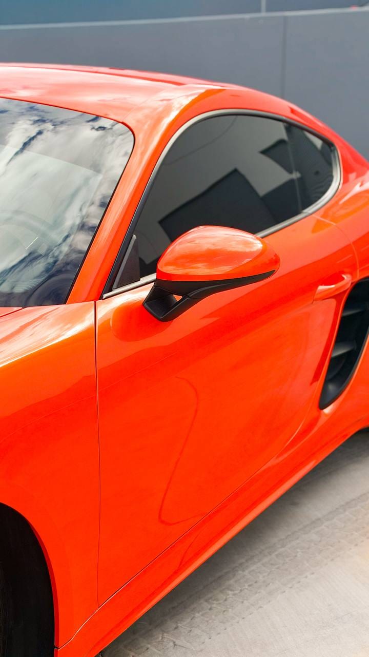 2020 Porsche 718 Cayman S color change wrap from Miami Blue to blaze orange at Purple Flare Wraps in Henderson