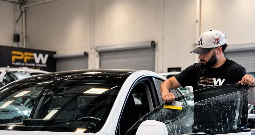 Installing ceramic window tint on a white Tesla Model Y